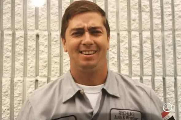 Rychlik's mechanic in a shop shirt